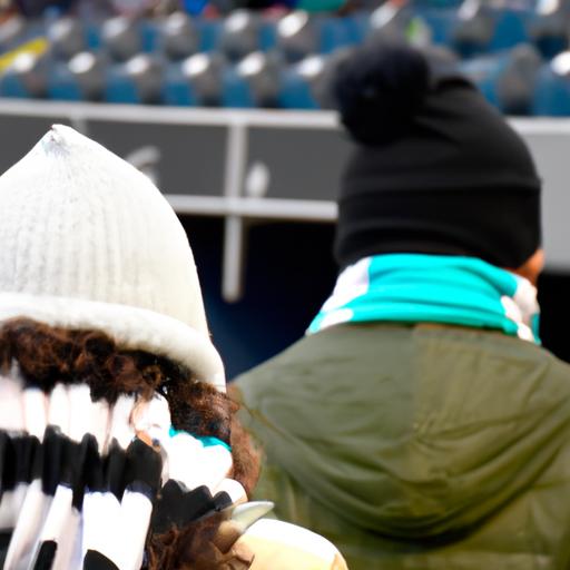 Cổ động viên mặc khăn quàng và mũ len, dũng cảm đối mặt với thời tiết lạnh giá để cổ vũ cho đội bóng tại sân vận động ngoài trời.